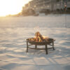 Beach bonfire fire pit setup at sunset in Miramar Beach