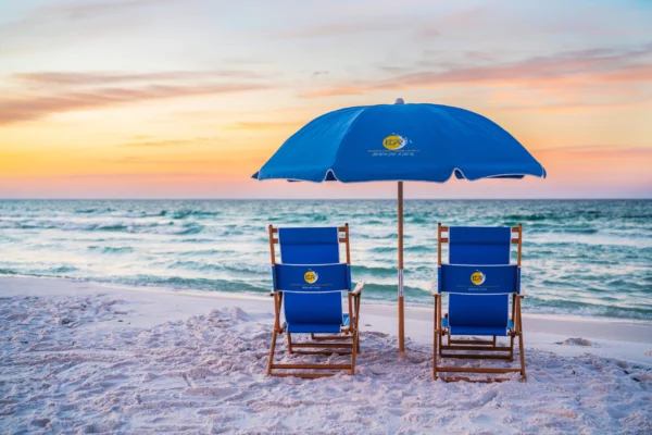 Two resort-style beach chairs and one umbrella