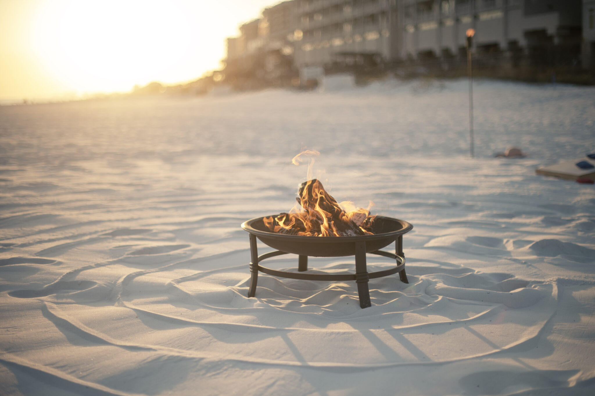Beach bonfire fire pit with a colorful sunset